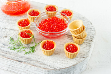 Tartlets with butter and red caviar. Gourmet food, appetizer. Delicatessen. Seafood.