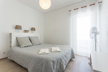 Minimalistic bedroom in bright colors and white walls. European style.