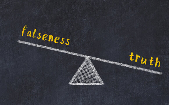 Chalk drawing of scales with words falseness and truth. Concept of balance