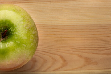 Signle green apple on a wooden background