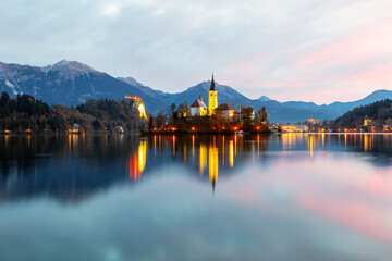 Cozy sunrise on Lake Bled against the backdrop of the castle in the Julian Alps in the Tirglav National Park