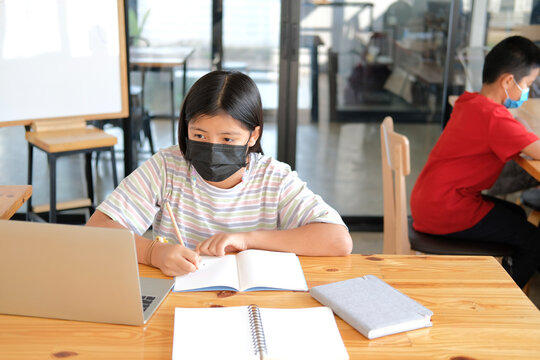 Boy Girl Student Wearing Face Mask Studying Learning Lesson Online. Remote Meeting Distance Education At Home