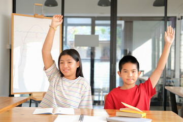 girl boy student studying raising hand in classroom. learning education at school