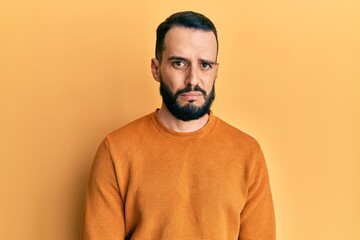 Young man with beard wearing casual winter sweater depressed and worry for distress, crying angry and afraid. sad expression.