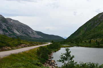 long road through mountain valley in summer