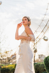 bride in wedding women's suit, background Ferris Wheel and nature