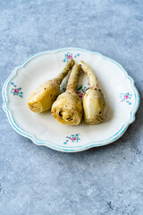 Marinated Spicy Artichoke Hearts in Olive Oil served with Root.