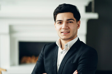 Fototapeta premium portrait of a lawyer in a bank looking at the camera smiling. a man in a business suit is in a modern, stylish office. general manager