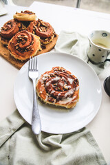 Cinnamon rolls buns on a white plate simple background 