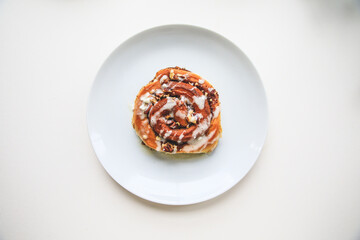 Cinnamon rolls buns on a white plate simple background 