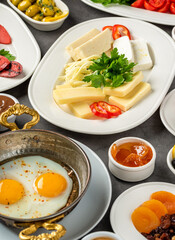 Traditional Turkish Breakfast served with traditional turkish tea on stone table
