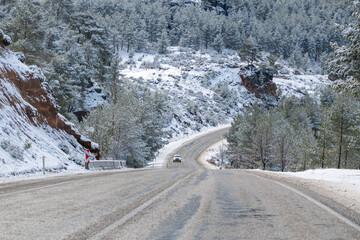 Fototapeta premium scenic view of the road in the forest with snow covered.
