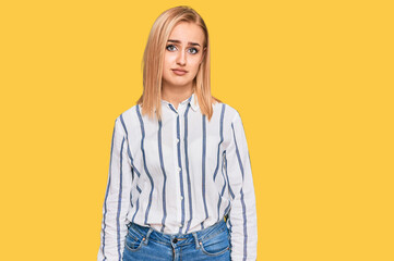 Beautiful caucasian woman wearing casual clothes looking sleepy and tired, exhausted for fatigue and hangover, lazy eyes in the morning.