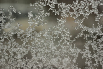 The sleet clung to the window and turned to ice