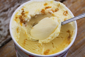 Ice cream with macadamia nuts and caramel, closeup
