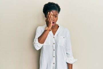 Young african american girl wearing casual clothes yawning tired covering half face, eye and mouth with hand. face hurts in pain.