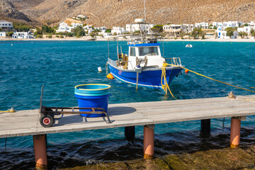 Fishing boat mooring in the port of Karavostasi on Folegandros island. Cyclades, Greece