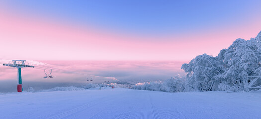 Ski resort, beautiful morning landscape. Ski trail trees and sky.