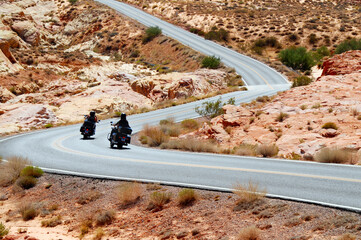 motorcycle riding in Valley of fire State Parkt on empty highway in scenic landscape