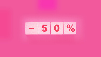 Minus 50% phrase on wooden blocks on black background. Sale business concept