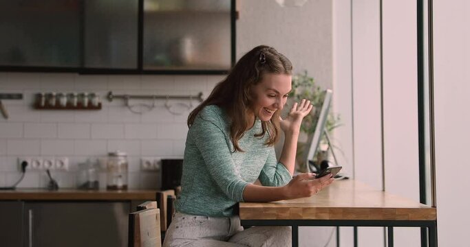 Excited young woman looking at phone screen, getting online lottery win notification or message with shopping promo code using internet store client loyalty program, feeling satisfied with discount.