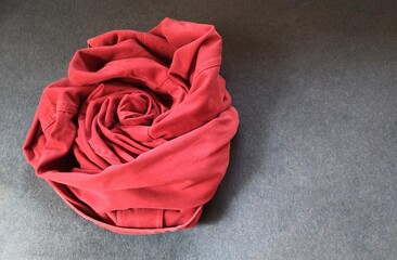 The red rose is formed by the roll over the coat.