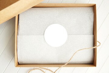 Round sticker mockup for gift, product label mockup, circle gift tag, thank you sticker on kraft paper box.