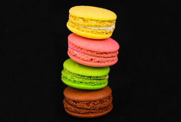 Macarons french macaroons on a black background.