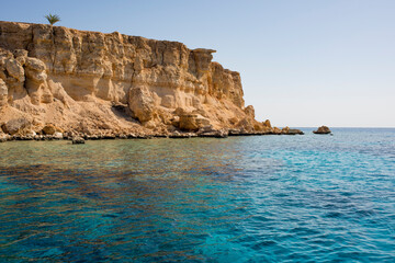 Fototapeta na wymiar beautiful seascape with clear turquoise and blue water and bright yellow rocks off the coast of Sharm El Sheikh in egypt 