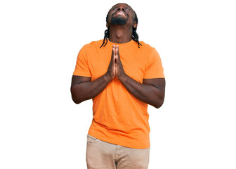 Handsome young african american man wearing casual clothes begging and praying with hands together with hope expression on face very emotional and worried. begging.