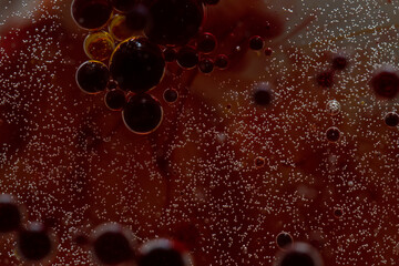 macro picture of oil bubbles in red water, looking like blood