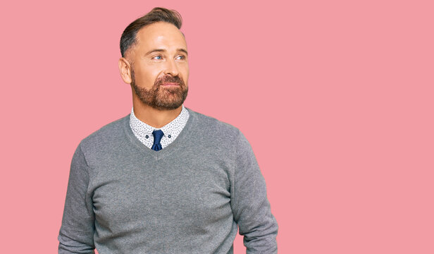 Handsome middle age man wearing business clothes smiling looking to the side and staring away thinking.