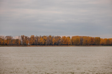 The Side Of Danube River In Galati, Western Moldavia, Romania With Autumnal Trees In Background,...