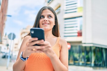 Young middle east girl smiling happy using smartphone at the city.