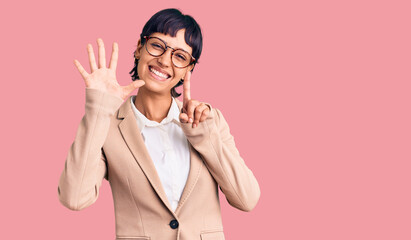 Young brunette woman with short hair wearing business jacket and glasses showing and pointing up with fingers number six while smiling confident and happy.