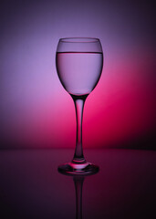 silhouette of transparent glass on purple background