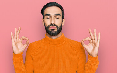 Young hispanic man wearing casual clothes relax and smiling with eyes closed doing meditation gesture with fingers. yoga concept.