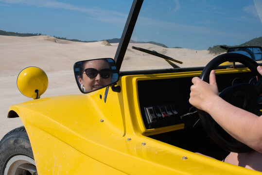 Woman driving on sand dunes - Powered by Adobe