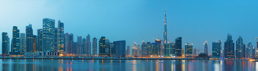 Fototapeta na wymiar Dubai - The evening panorama over the new Canal with the Downtown and Burj Khalifa tower.