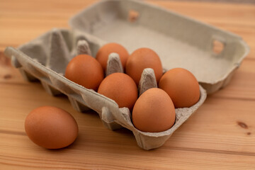 eggs in a package on a wooden table, ingredients