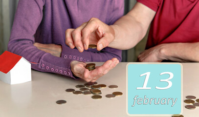 Obraz premium February 13, 13th day of month. Reminder to plan family budget together for woman and man. Winter month.Day of the year concept.