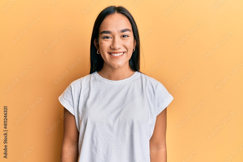 Poster young asian woman wearing casual white t shirt with a happy and cool smile on face. lucky person.