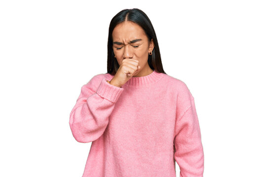 Young asian woman wearing casual winter sweater feeling unwell and coughing as symptom for cold or bronchitis. health care concept.