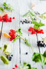 Ripe viburnum berries on a white old wooden background