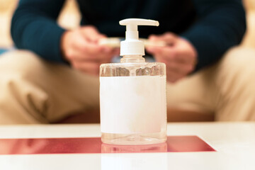 
hydroalcoholic gel on a table in a living room and behind a person sleeping