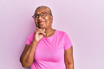 Senior african american woman wearing casual clothes and glasses serious face thinking about...
