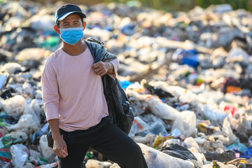 Poor people collect garbage for sale People living in garbage heaps walking to collect recyclable waste to be sold to poverty concept world environment day
