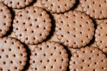 Texture background of rows of chocolate-cream cookies.