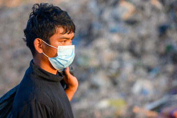 Poor people collect garbage for sale People living in garbage heaps walking to collect recyclable waste to be sold to poverty concept world environment day