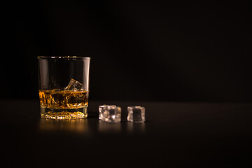 glass of whiskey on black background